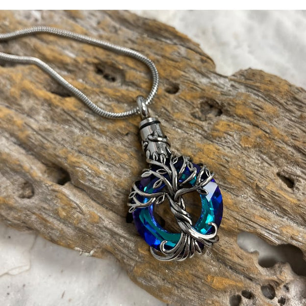 Iridescent Tree of Life cremation pendant for ashes—blue-green cut-glass urn pendant with 22-inch chain; elegant cremation jewelry necklace and urn necklace for men, women, and pet ashes jewelry seekers searching “cremation jewelry near me.”
